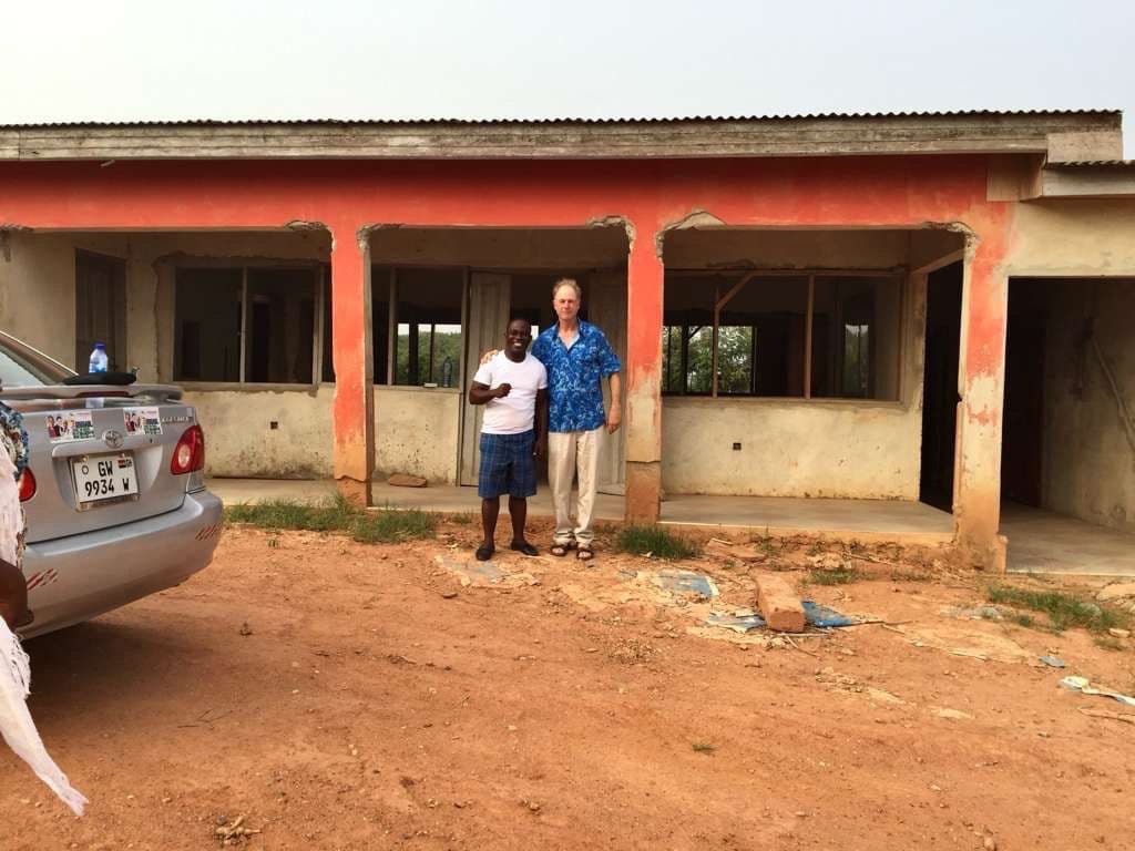 Mike and Pastor John standing in front of the building